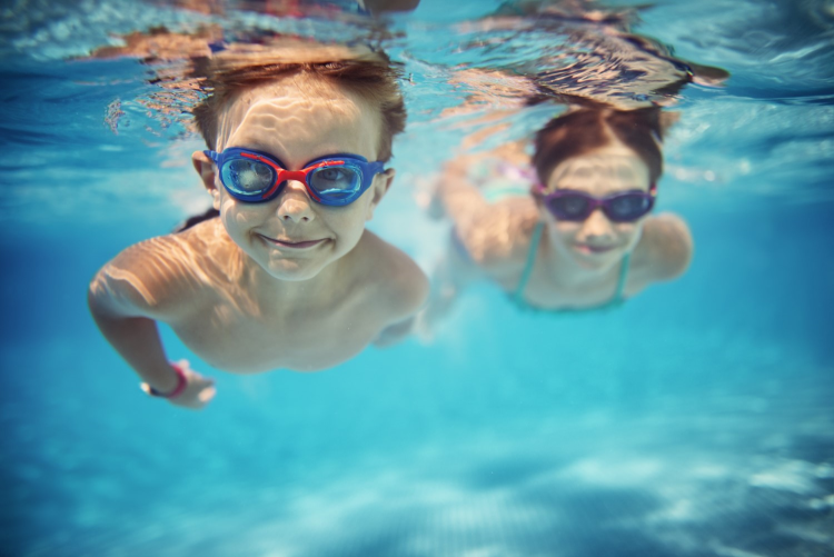 two children swimming underwater